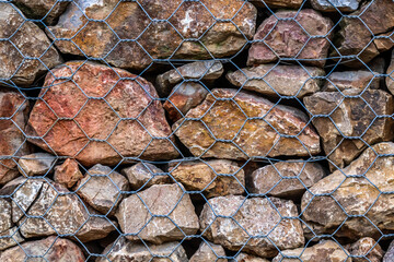 Stone wall reinforced with metal mesh. Stone wall texture background photo