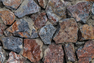 The texture of the stone wall. Old castle stone wall texture background. Stone wall as background or texture. Part of a stone wall for background or texture.