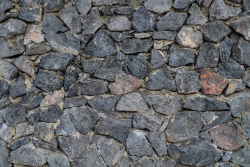 The texture of the stone wall. Old castle stone wall texture background. Stone wall as background or texture. Part of a stone wall for background or texture.
