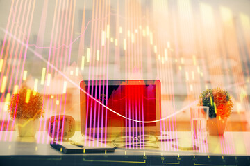 Stock market graph on background with desk and personal computer. Multi exposure. Concept of financial analysis.