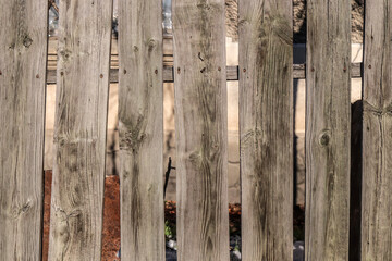 Old wooden fence from a picket fence.Dim village landscape