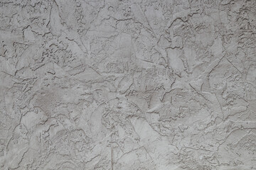 Surface puttied with decorative putty as a background. Preparation of facade walls