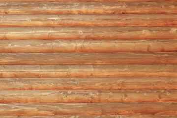 Wooden log house as a background.Wooden background from round logs with natural wood pattern