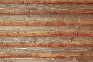 Wooden log house as a background.Wooden background from round logs with natural wood pattern