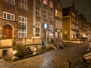 Fototapeta na wymiar View of the street in the center of the old town at night. Architecture of an old historic street in Gdansk. Old town tourist attraction. Gdansk, Poland.