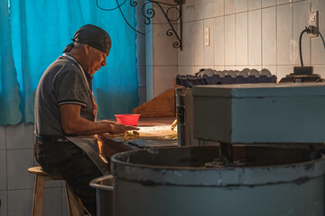 happy adult man working in a bakery