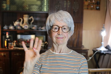 Senior woman saluting with hand gesture © ajr_images