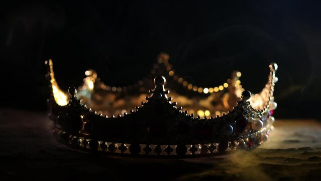 Fabulous golden crown of the king on a dark background. Panoramic view of the blue and red fog. Mockup for your logo. 