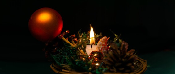 Christmas decoration with candle on blackground