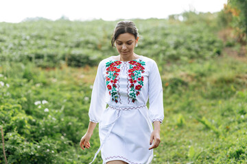 Ukrainian young girl in traditional national folk women's costume. Ukraine is independent. Ukrainian girl in the village - 559213000