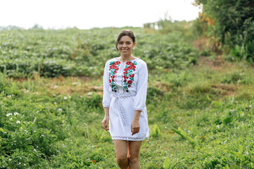 Ukrainian young girl in traditional national folk women's costume. Ukraine is independent. Ukrainian girl in the village - 559213022