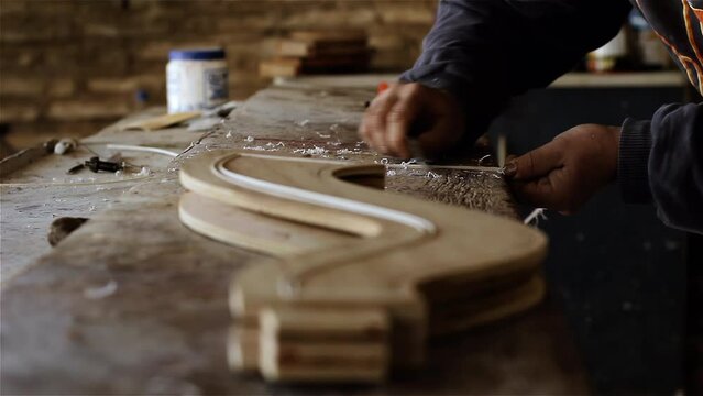 Hands of a Traditional Harp Maker Working at his Workshop in Asuncion, Paraguay. Close Up. 4K Resolution.