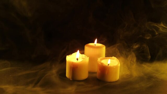 Candles in smoke on a dark background. Panoramic mockup for your logo. Horizontal banner with copy space for popular social media website cover image.