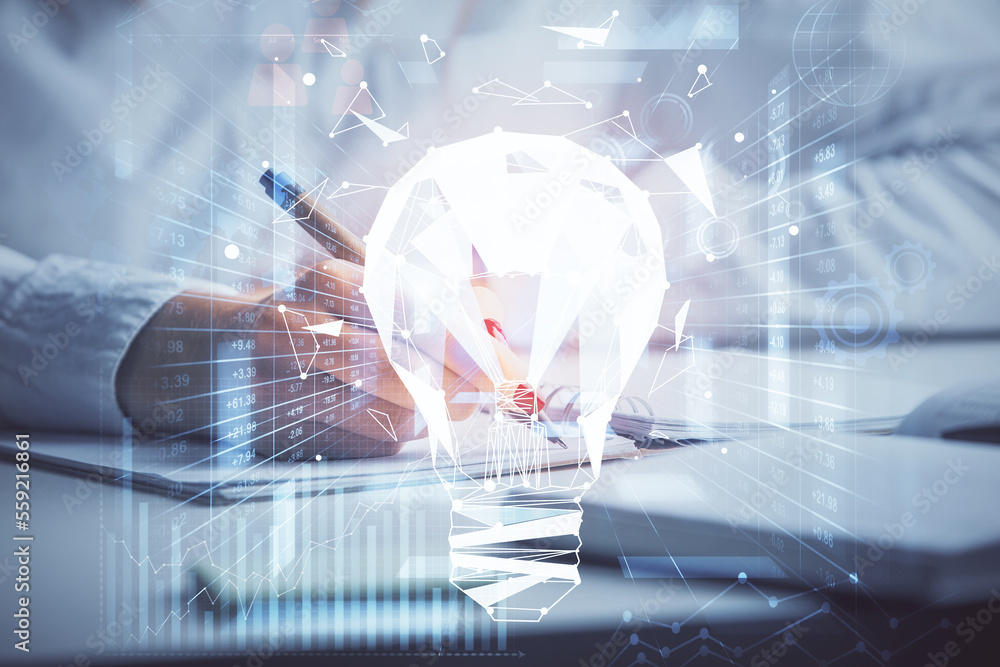 Poster bulb hologram over hands taking notes background. concept of idea. double exposure