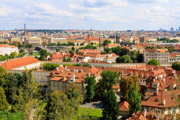 Fototapeta na wymiar Roofs of houses and a view of the city of Prague. Background with selective focus and copy space