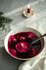 Bowl of traditional Ukrainian Christmas dish - borsch with vushka (porcini dumplings) prepared for Christmas Eve supper. 
