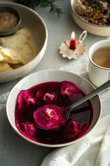 Bowl of traditional Ukrainian Christmas dish - borsch with vushka (porcini dumplings) prepared for Christmas Eve supper. 