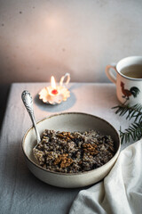 Kutia - essential traditional Ukrainian Christmas sweet dish prepared for Christmas Eve supper and cup of  uzvar on linen tablecloth.