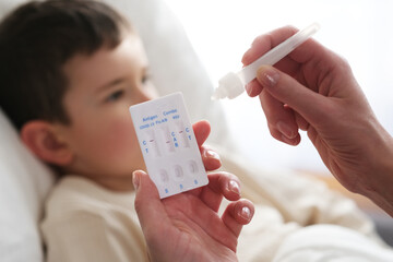 A little boy is sick, a combo antigen test (covid-19, flu a b, RSV) is needed for proper diagnosis. - obrazy, fototapety, plakaty