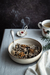 Kutia - essential traditional Ukrainian Christmas sweet dish prepared for Christmas Eve supper and cup of  uzvar on linen tablecloth.