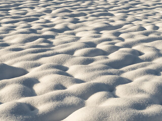 A plowed farmland covered with a layer of white snow