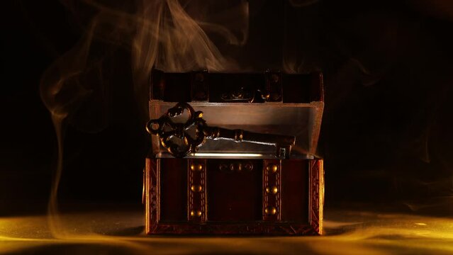 Mysterious chest and key on a dark background. Panoramic mockup for your logo. Horizontal banner with copy space for popular social media website cover image.