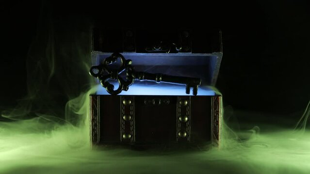 Mysterious chest and key on a dark background. Panoramic mockup for your logo. Horizontal banner with copy space for popular social media website cover image.