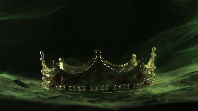 Fabulous golden crown of the king on a dark background. Panoramic view of the fog. Mockup for your logo.