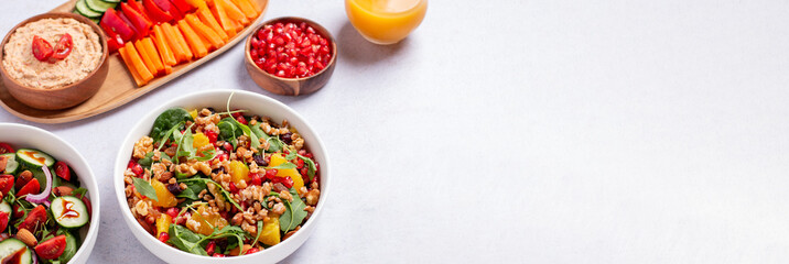 Obraz na płótnie Canvas Vegan or veganuary feast with various salads ad healthy plates on light gray table