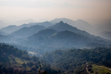 Hills in haze on the Aegean coast enlighten by evening sunlight