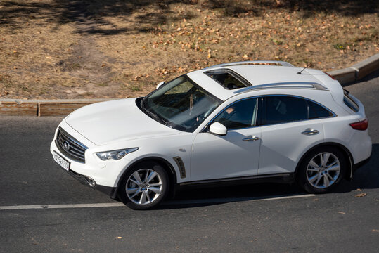 Moscow, Russia - September 27, 2022: White Infiniti FX II 2011 driving down the road (QX70 Infiniti FX30d S (S51)