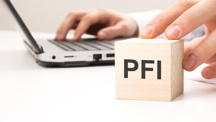 PFI text wooden block on white table background. Idea, strategy, advertising, marketing, keyword...