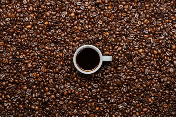 Cup of espresso, roasted coffee beans
