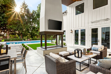 Outdoor Covered Patio, Pool, and Fireplace in Back yard of New Luxury Home