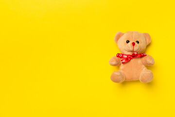 Cute teddy bear on color background, top view