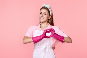 woman in rubber gloves showing heart gesture
