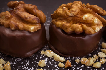 Close up of homemade with dark chocolate pralines filled with walnuts and  marzipan