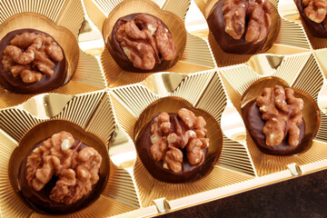 Close up of homemade with dark chocolate pralines filled with walnuts and  marzipan