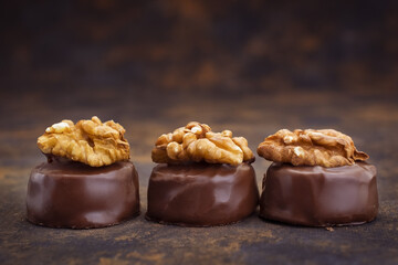 Close up of homemade with dark chocolate pralines filled with walnuts and  marzipan