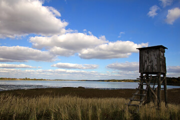 Observation tower hunting pulpit,  autumn landscape on the , blue sky and dried grass.