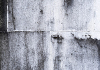White concrete wall with black mildew stains grunge background texture