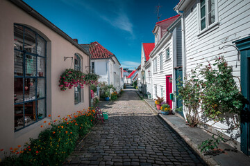 Old town Gamle Stavanger with white timber houses in Norway, during sunshine and blue sky