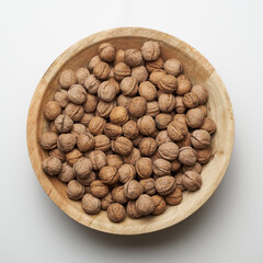 Walnuts wooden bowl top view