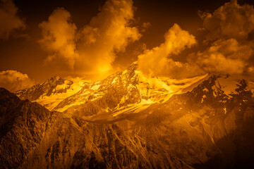 Fantasy orange aerial view of Palla Bianca massif and its surrounding glaciers. Vallelunga, Alto...
