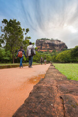 Visitors on the way up to Sigiriya Sri Lanka. Path for tourists to climb the Lion Rock. Garden with...