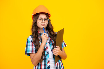 Renovation for childrens room. Little girl in protective helmet and paint brush for painting walls....