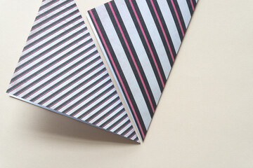 two folded scrapbook paper sheets with stripes