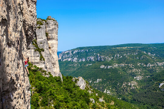 A wide angle perspective on Nina Caprez venturing up on a demanding limestone crag.