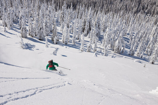Male Skier Makes A Turn In Fresh Powder While Skiing In The Whitefish Range