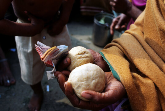 Mother of the child is carrying money and child's hair wrapped in special bread dough as an offering during Chudakarana Samskara